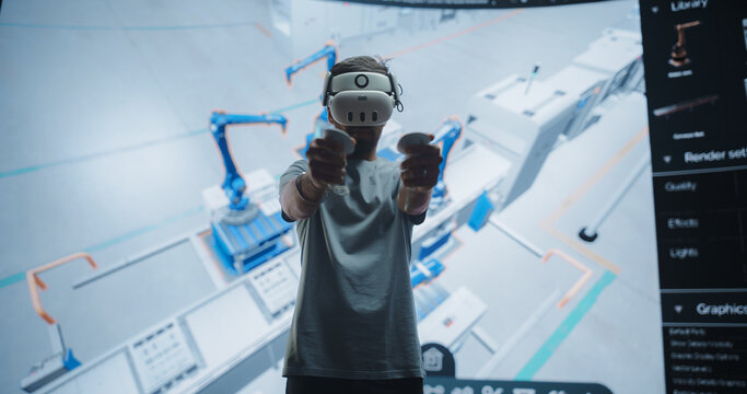 Robotics Specialist Programs a Group of Robotic Arms with the Help of Virtual Reality Application. Specialist Utilizes VR to Program the Assembly Line, Optimize Production and Improve Efficiency
