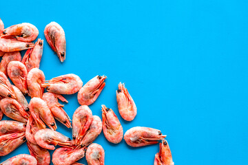 Prawn background on blue table top view frame copy space