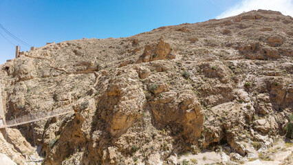 Rugged Desert Landscape with Suspension Bridge