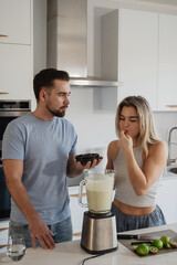  Couple Preparing Healthy Smoothie Together in Bright Modern Kitchen