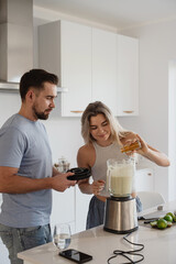  Couple Preparing Healthy Smoothie Together in Bright Modern Kitchen
