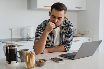  Man Working from Home with Coffee and Snacks in Modern Kitchen