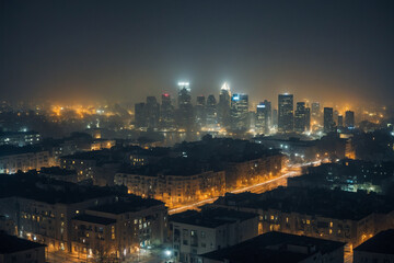 Fototapeta premium A foggy night city view featuring faint building outlines and streaked light sources blending into the mist in a soft blurred atmosphere, the subtle layering of architectural shapes