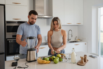Couple Preparing Healthy Smoothie Together in Bright Modern Kitchen