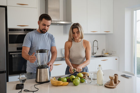  Couple Preparing Healthy Smoothie Together in Bright Modern Kitchen - Powered by Adobe