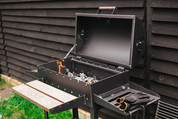 A black barbecue grill with a fire burning, ready for a cookout on a summer day. An outdoor...