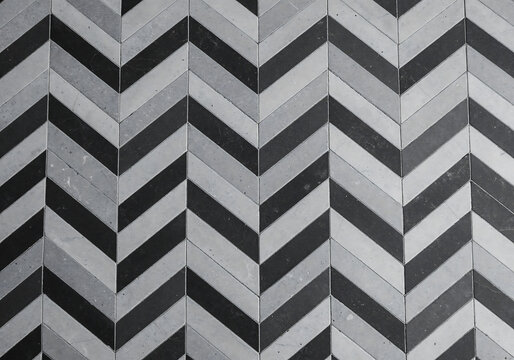 Top-Down View of Monochrome Chevron Tile Pattern with Black, Gray, and White Geometric Design