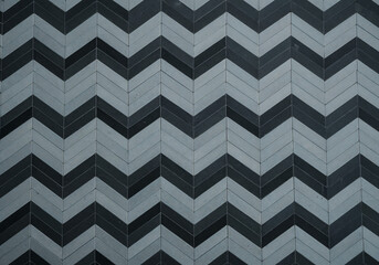 Top-Down View of Monochrome Chevron Tile Pattern with Black, Gray, and White Geometric Design