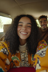 Smiling young woman taking a selfie in the backseat of a vintage car while sitting with a friend during a road trip