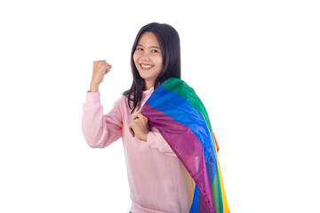 Confident young Asian woman wearing a pink sweatshirt, smiling and raising a fist in a powerful...