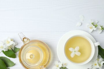 Green tea with jasmine in cup and teapot on white background, top view