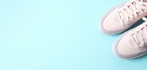 Pink sneakers on a blue background, top view