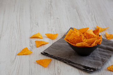 Crunchy Nacho BBQ Tortilla Chips in a Bowl, side view. Copy space.