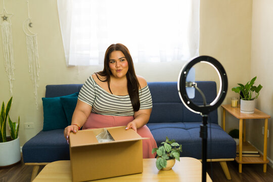 Plus size influencer unboxing product at home