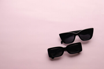 Sunglasses on a plain background. Summer, chamomile