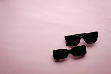 Sunglasses on a plain background. Summer, chamomile