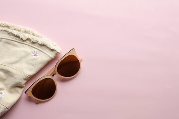 Sunglasses on a plain background. Summer, chamomile