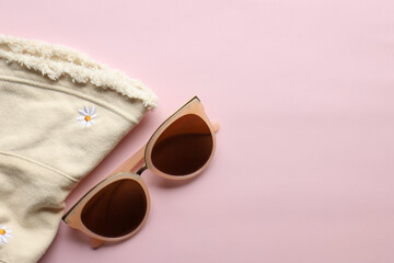 Sunglasses on a plain background. Summer, chamomile
