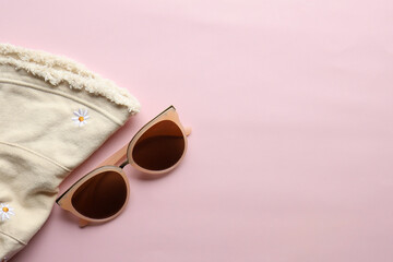 Sunglasses on a plain background. Summer, chamomile