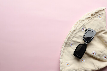 Sunglasses on a plain background. Summer, chamomile