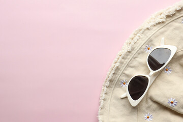 Sunglasses on a plain background. Summer, chamomile