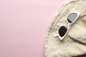 Sunglasses on a plain background. Summer, chamomile
