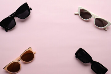 Sunglasses on a plain background. Summer, chamomile
