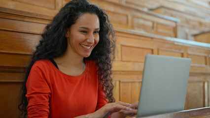 Smiling happy positive Latina woman smile looking at camera student girl female typing laptop...