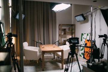 The interior of a recording studio is equipped with professional filming equipment for recording...