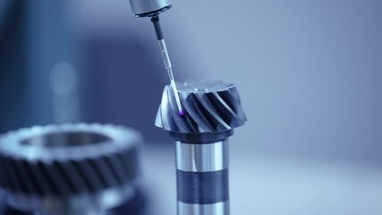 Cnc coordinate measuring machine analyzing metal gear for precision engineering.