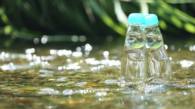 Two glass bottles of ramune soda in a cool river, Beverage or drink, Nobody