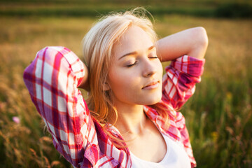Beautiful blonde woman with closed eyes.