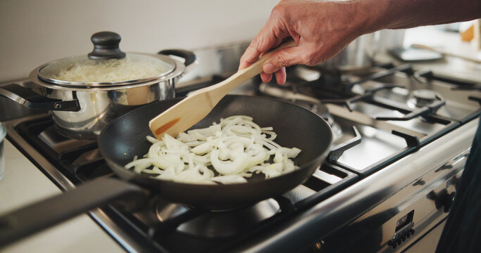 Cooking, hands and chef with pan in kitchen, culinary skills or meal prep for dinner or ingredients. Catering business, entrepreneur and person with recipe for gourmet, process and onions to saute