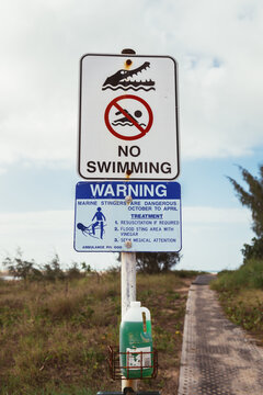 Sign warning about both crocodiles and stingers in the water