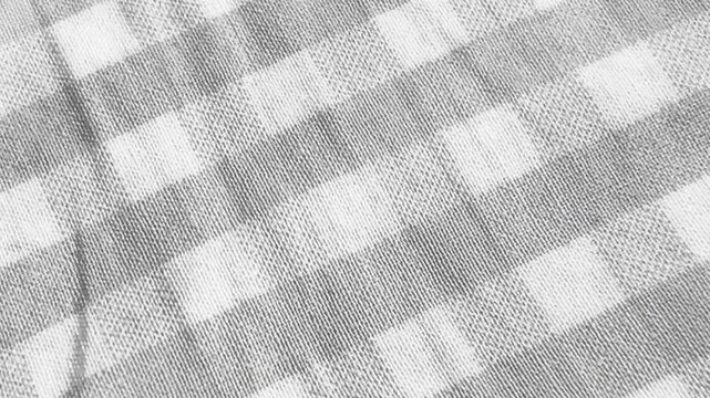 Close-up of neutral grey and white checkered fabric with diagonal gingham pattern. A minimalist and clean textile background loop with rustic appeal