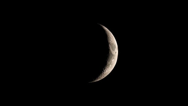 Moon, crescent, astronomy: A luminous thin crescent moon glows brightly against the deep black sky, revealing intricate craters, mountains, and maria in high-resolution detail, highlighted by Earthshi