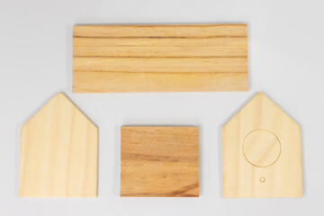 Wooden Birdhouse Pieces with Roof and Wall Panels Laid Out Flat on White Background