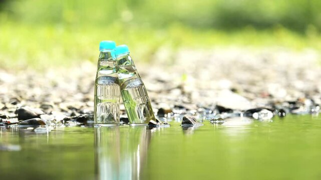 Two glass bottles of ramune soda in a cool river, Beverage or drink, Nobody