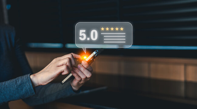 A person uses a smartphone to give a 5-star review, highlighting positive feedback and customer satisfaction through digital rating.