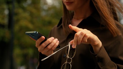 Confused Caucasian woman with mobile phone lost direction in city searching location address...