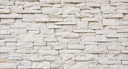 Textured light beige stone wall with irregular horizontal stacked blocks