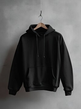 Black hoodie hangs on a hanger