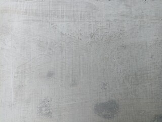 Scratched and Weathered White Wall Texture. Close-up of a scratched, slightly stained white wall surface with subtle grunge textures and vertical lines, ideal for backgrounds or overlays