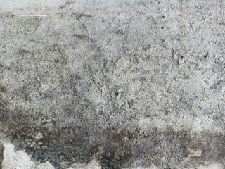 Rough Grunge Concrete Wall Texture with Stains and Cracks. Close-up of a weathered concrete wall...