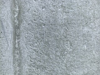 Rough White Concrete Wall Surface. Close-up of a rough white concrete wall texture with natural imperfections and weathered surface, ideal for design backgrounds and industrial themes