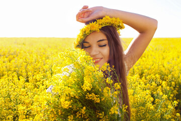 Happy girl with a bouquet of wildflowers.
