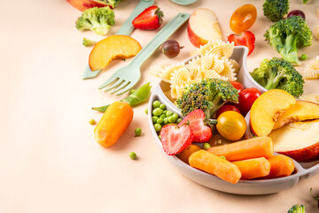 Baby finger food, various baby snacks, pasta, vegetables, fruits chopped for convenient, safe children's lunch, teaching small child to eat healthy food
