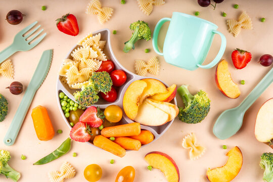 Baby finger food, various baby snacks, pasta, vegetables, fruits chopped for convenient, safe children's lunch, teaching small child to eat healthy food