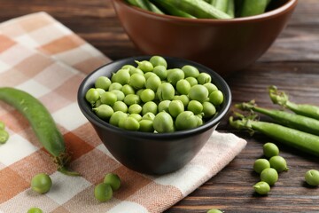 Fresh ripe green peas on wooden table, closeup