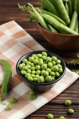 Fresh ripe green peas on wooden table, closeup